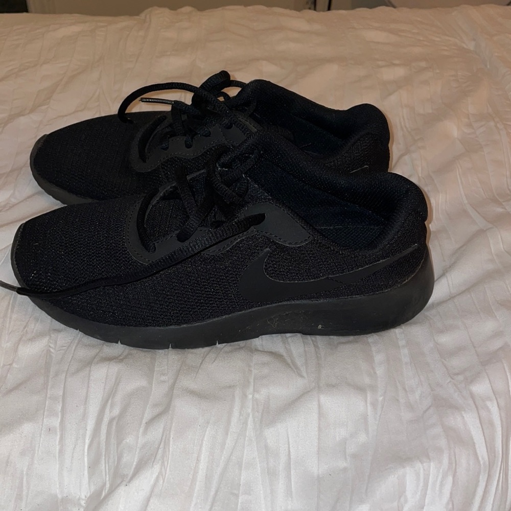 All black Nike shoes